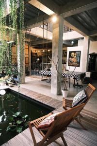 a patio with a pool and two chairs and a table at Teras Sabin in Ngabean