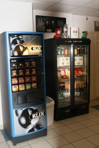 two soda machines are next to each other at ibis budget Nevers Varennes Vauzelles in Varennes Vauzelles