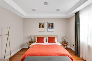 a bedroom with a large bed with orange sheets at Amazing Bosphorus View Apartment in Istanbul