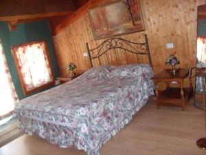 a bedroom with a bed and a wooden wall at Giamia Villas in Sulmona
