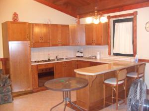 a kitchen with wooden cabinets and a table in it at Giamia Villas in Sulmona +4 photos