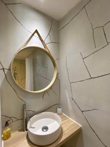 a bathroom with a white sink and a mirror at Le Cyprès de Casimir in Beaucaire +11 photos
