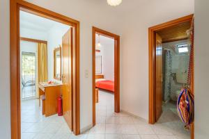a hallway with two doors to a room with a bathroom at Hara's Apartment 1 in Keratokampos +31 photos