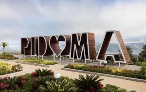 a large sign that reads dipwana in a garden at Pidoma Resort in Sen Monorom