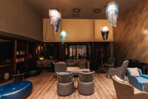 a waiting room with tables and chairs and animals on the wall at Palmon Bay Hotel & Spa in Herceg-Novi