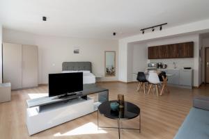 a living room with a flat screen tv on a couch at Leochares Lifestyle Apartments - Self check-in in Athens