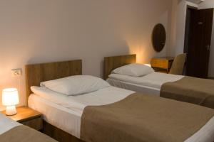 Postel nebo postele na pokoji v ubytování Lileo Inn Hotel