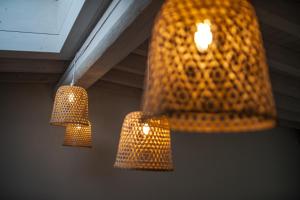 a couple of lights hanging from a ceiling at Fantastica casa in stile mediterraneo - Al Ficodindia in Torre San Giovanni Ugento