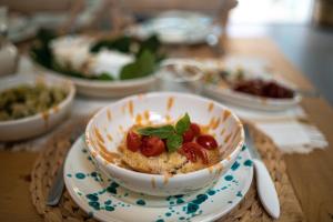 a bowl of food on a plate on a table at Fantastica casa in stile mediterraneo - Al Ficodindia in Torre San Giovanni Ugento +37 photos