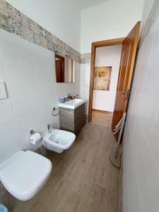 a bathroom with a toilet and a sink at Appartamento Acquamarina Torre Canne in Torre Canne