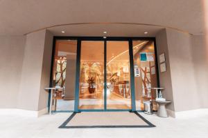 an entrance to a building with glass doors at Palmon Bay Hotel & Spa in Herceg-Novi