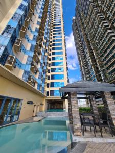 a swimming pool in front of two tall buildings at Roxas Blvd Stunning Studio Condo Near US Embassy in Manila