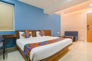 a bedroom with a large bed in a room at FabHotel Blue Marine in Indore