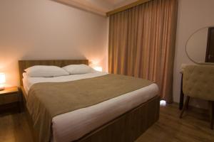 Postel nebo postele na pokoji v ubytování Lileo Inn Hotel