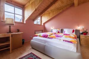 a bedroom with a large bed in a attic at Bbmarlene in Bolzano