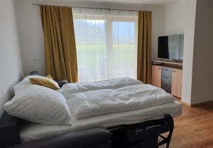 two beds in a room with a large window at Appartement Heimatliebe in Schladming