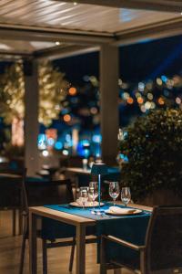 a table in a restaurant with wine glasses on it at Palmon Bay Hotel & Spa in Herceg-Novi