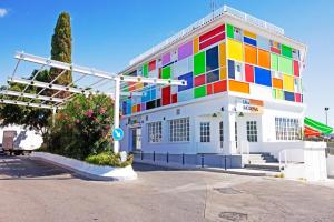 a building with a colorful facade on a street at Hotel Kuve Marbella in Marbella