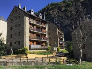 a building with balconies on the side of a mountain at Paso del Onso in Escarrilla