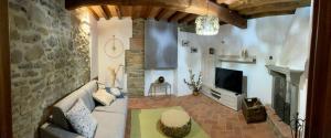 a living room with a couch and a fireplace at Villa Borgo Soale in Reggello