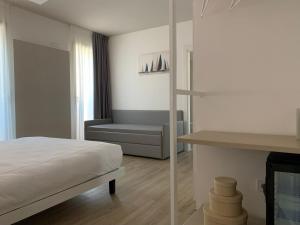 a bedroom with a bed and a bench in a room at La Casa Di Filò Boutique in Roseto degli Abruzzi