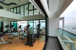 a gym with treadmills and ellipticals in a building at Sunrise Gurney Premium Suite - Gurney Drive in George Town