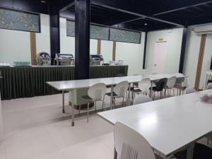 a row of tables and chairs in a restaurant at Mahayahay Lodge and Restaurant in Mactan