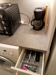 a counter with a toaster and a coffee maker on it at Cozy spot apt next to metro station . in Athens