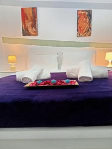 a bed with a tray of flowers on it at Cozy spot apt next to metro station . in Athens