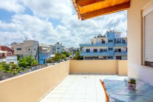 a balcony with a table and a view of the city at Ioannis Appartment in Heraklio Town