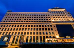 a large building with a sign on top of it at Hotel Tip Top International Pune in Pune