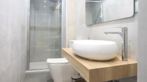 a bathroom with a sink and a toilet at Apartamentos Boutique Puerta de Reyes in Toledo +8 photos