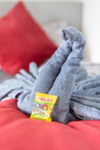 a person with their feet up on a bed with a book at FullHouse - Zwickau - L12 - 2 Single Beds - Nespresso - SmartTV in Zwickau +11 photos