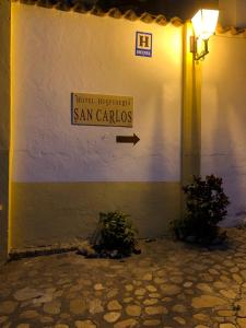 a building with a sign that reads san carlos at Hotel Hospederia San Carlos Villa De Leyva in Villa de Leyva