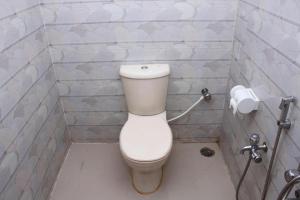 a bathroom with a toilet and a roll of toilet paper at Fanush Resort in Bāndarban