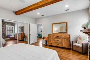 a bedroom with a white bed and a mirror at Historic City Market - Loft Off Broughton Too in Savannah