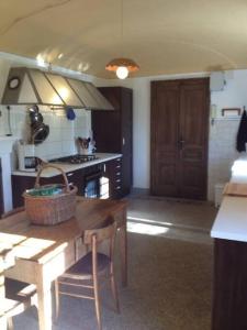a kitchen with a wooden table with a basket on it at Romantic Italian Castle at the foot of the Alps in Settimo Vittone
