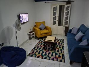 a living room with two couches and a table at Sunny modern apartment with good internet, near from city center of Alexandria in Alexandria