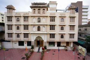 a large building in a city with a courtyard at Hotel Maru Casa in Jaipur