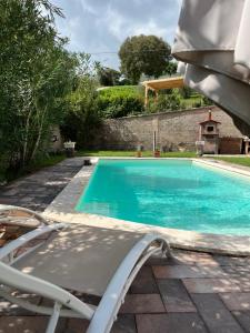 una piscina con una silla junto a ella en La casa di Silvia, en Cantalupo in Sabina