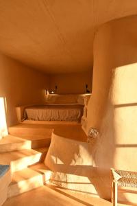 a room with two beds and a chair at Casa Mediterraneo Hotel in Meyisti