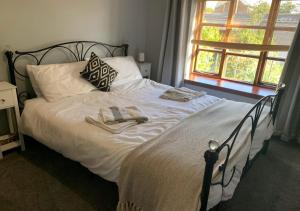 a bedroom with a bed with two towels on it at Burnside Cottages in Fettercairn