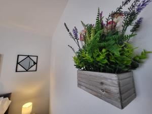 a wooden box filled with plants on a wall at Emerald House in Luton