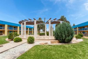 a park with a pavilion in front of a building at Days Inn & Suites by Wyndham Clovis in Clovis