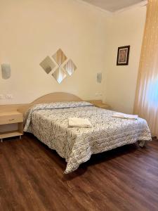 sypialnia z łóżkiem i drewnianą podłogą w obiekcie Hotel degli Dei w mieście Pianoro