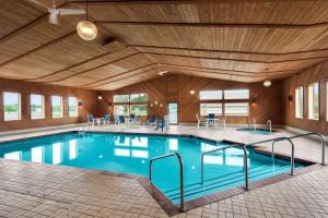 a large swimming pool with a wooden ceiling at Days Inn by Wyndham Hurley in Hurley