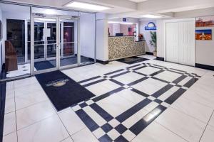 a lobby with a checkered floor in a building at Days Inn by Wyndham Hartsfield Jackson Atlanta Airport West in Atlanta