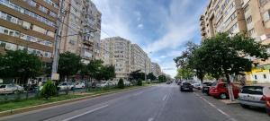 a city street with parked cars and buildings at Republicii Residence 2 in Ploieşti
