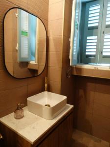 a bathroom with a sink and a mirror at 60 Indri Borg Townhouse in Rabat +11 photos
