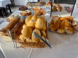 a table topped with baskets of bread and pastries at Hotel Panorâmico in Penha